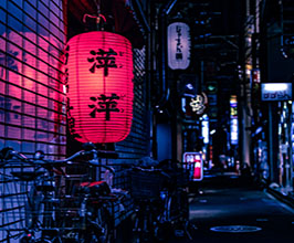 Downtown Japan with bikes and lanterns.